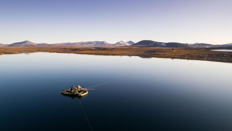 Researchers on a lake