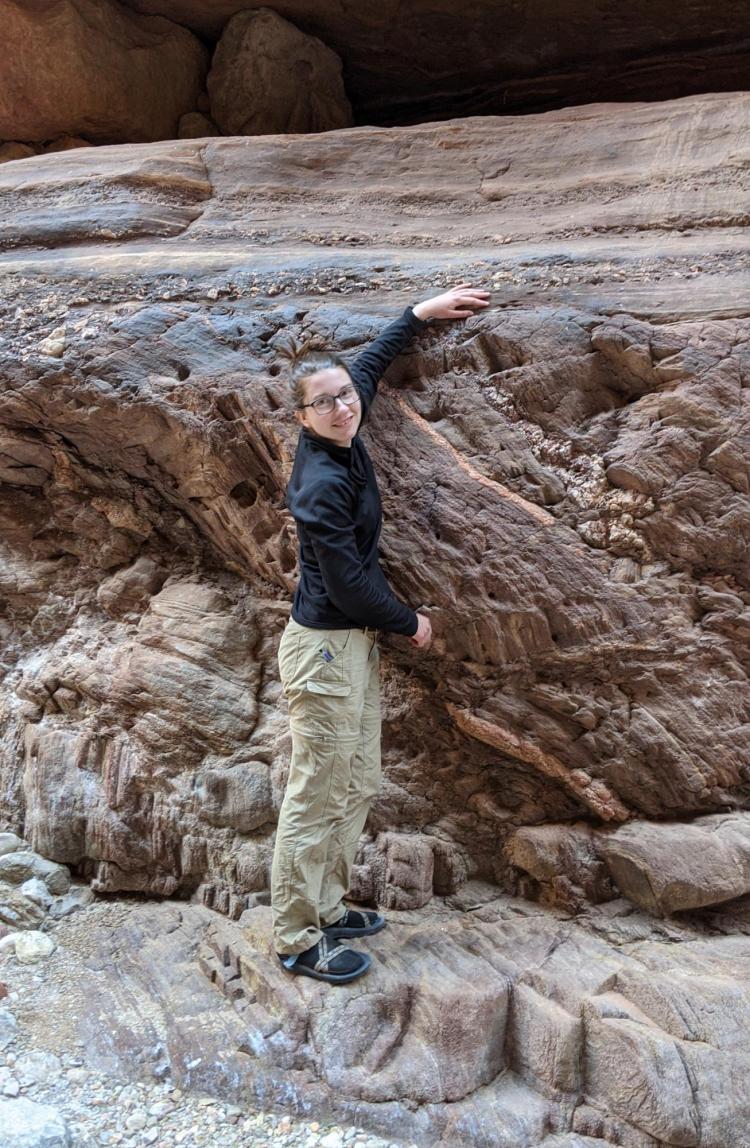 Barra Peak rests her hand on the line where old rocks and new rocks meet in the Grand Canyon. (Credit: Barra Peak)