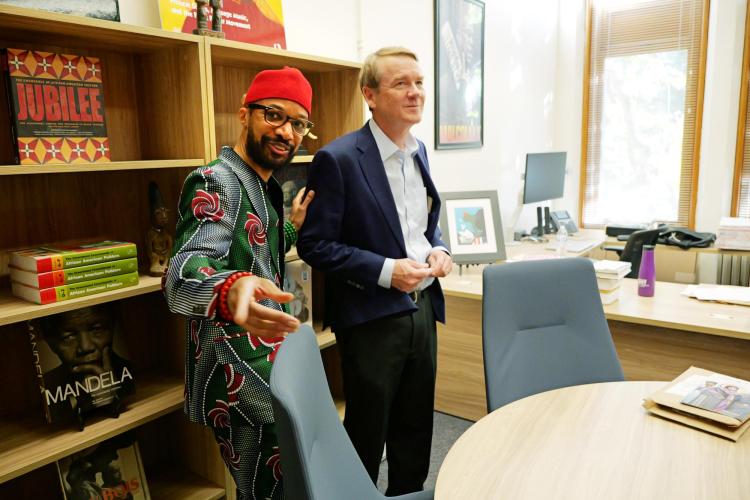 Sen. Michael Bennet visits with Reiland Rabaka, founder and director of the Center for African and African American Studies (CAAAS)