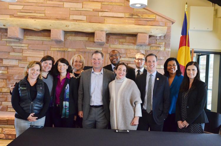 A group photo is taken at a bill signing ceremony on the CU Boulder campus.