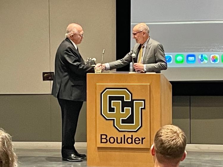 Provost Russ Moore congratulates Professor Wayne Boss