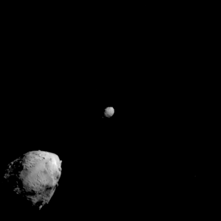 Large asteroid with smaller asteroid in background against the blackness of space