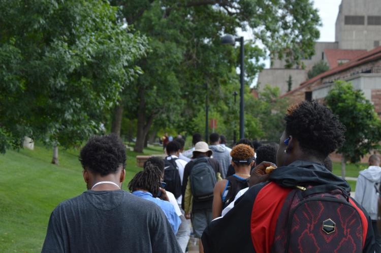 Participants in the boys2MEN Leadership Summit walk through campus