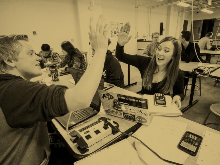 Students give each other a high five.