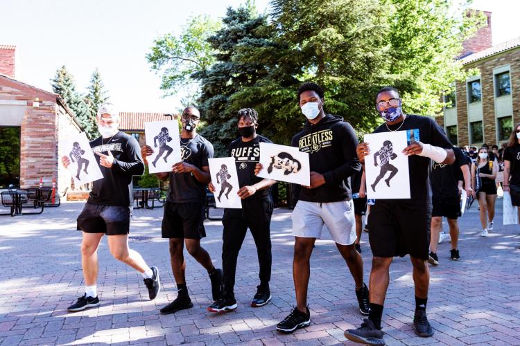 CU Boulder student athletes, administrators and community members marched from the Hill to the Pearl Street Mall in what was called the Buff March