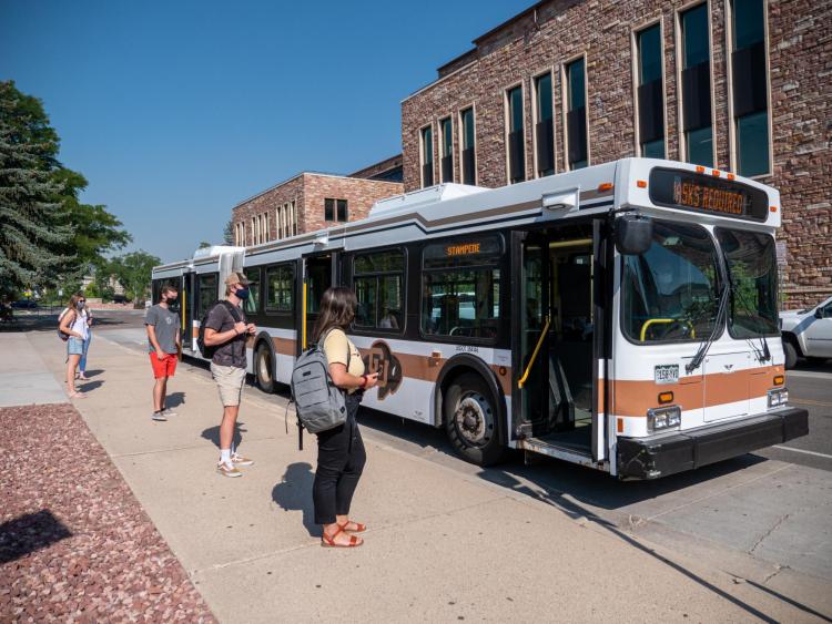 students wait to board Buff Bus
