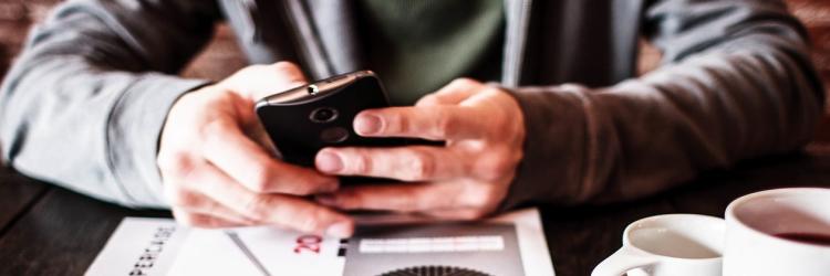 person typing on a cell phone