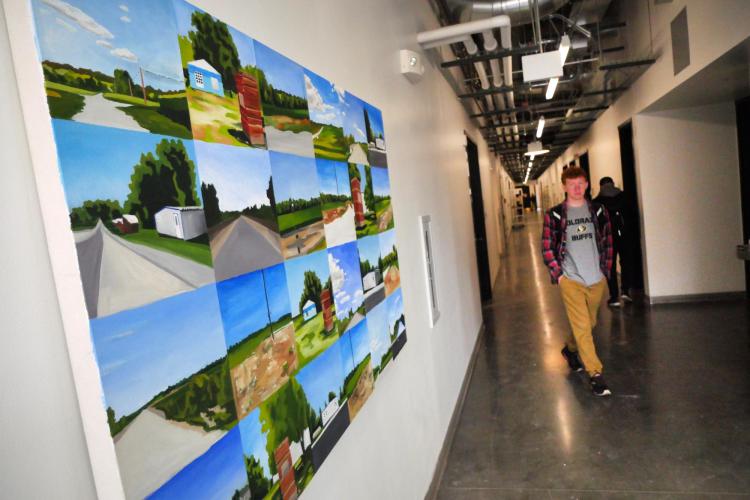 A student makes his way down a hallway in the Visual Arts Complex