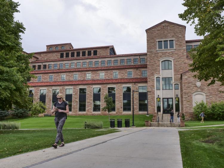 Student walks by Colorado Law building