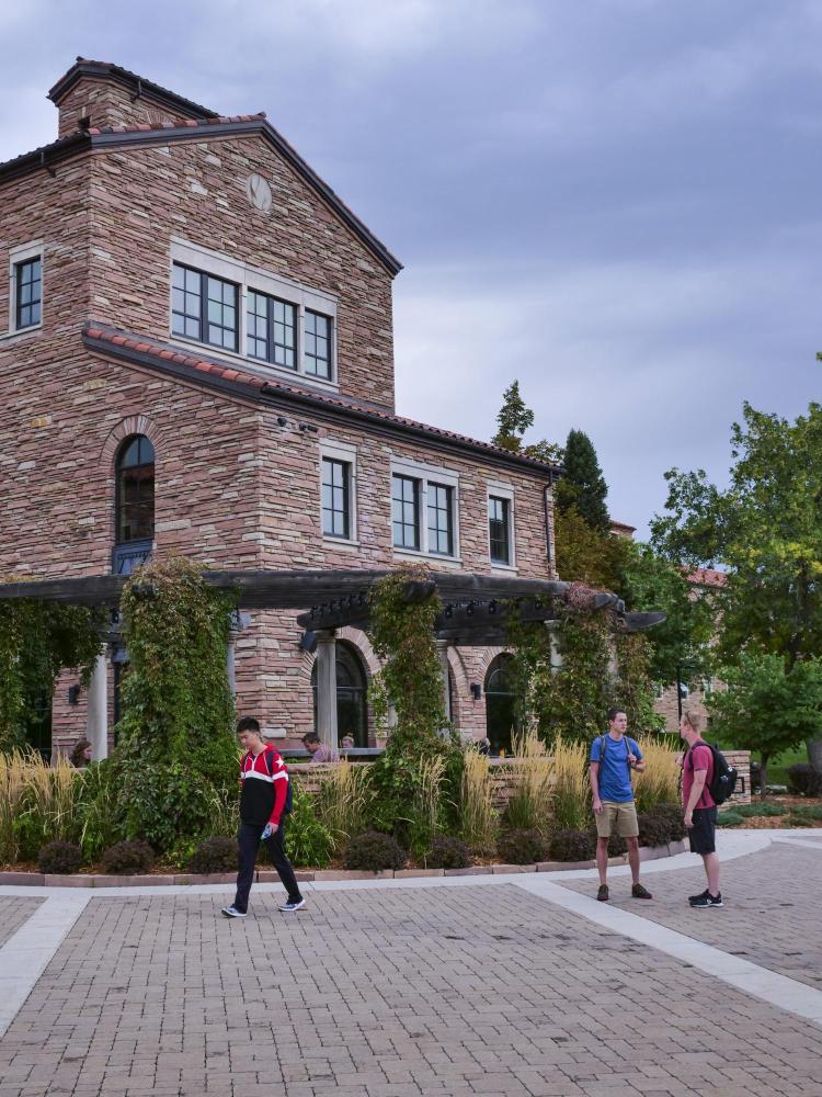 Students stand in front of C4C building