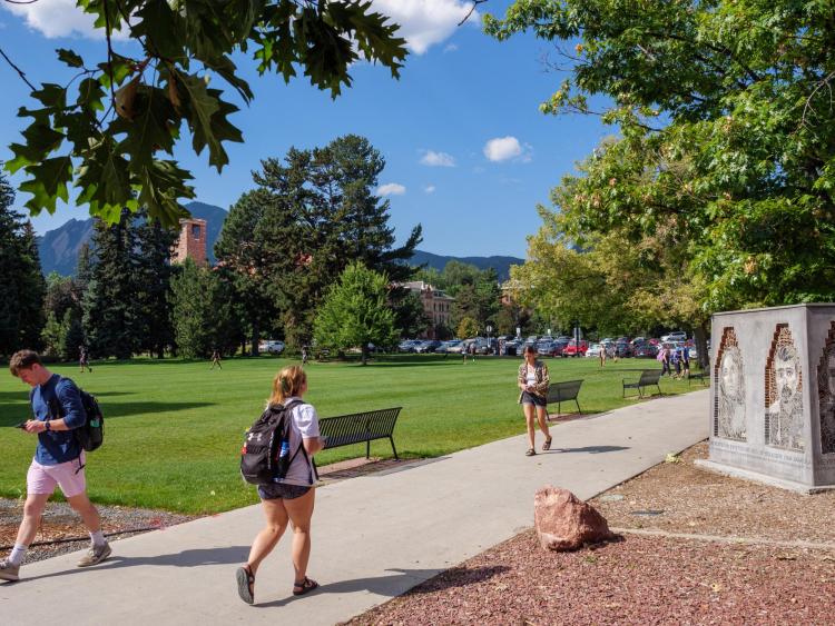Campus community members walking outside on campus