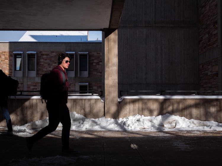 Student walking on a snowy campus
