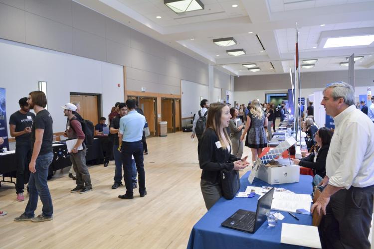 Student speaks with employer at the Career Fair