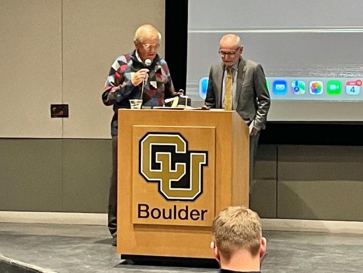 Provost Moore congratulates CU Distinguished Professor Marv Caruthers