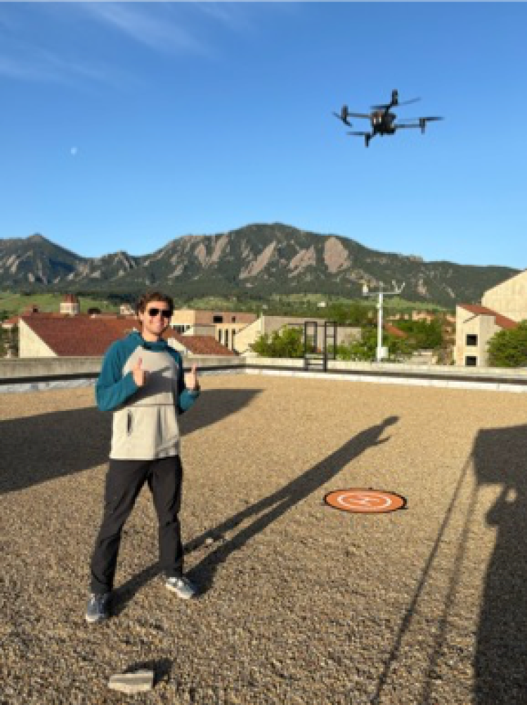 Chase Rupprecht launches a drone on campus during BOLDERBoulder in May.