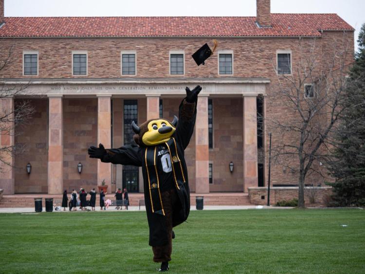 Chip tossing a graduation cap.