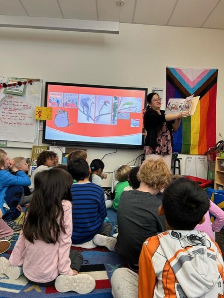 Graduate student assistant Christy Go plays a game of I Spy while reading to a class