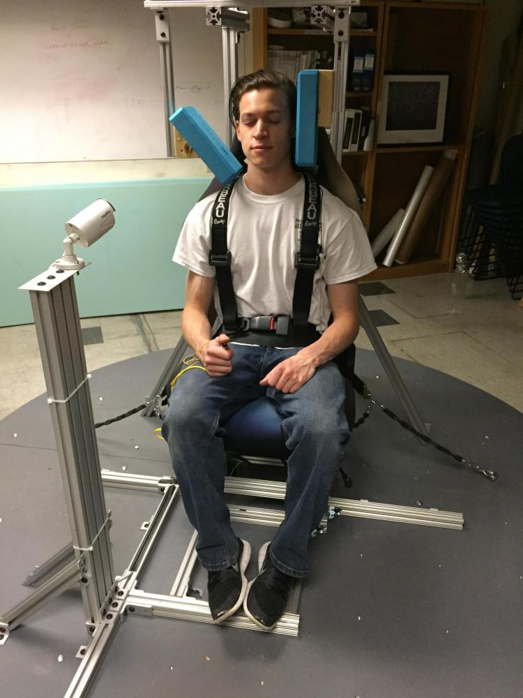 Test subject sitting in artificial gravity simulator