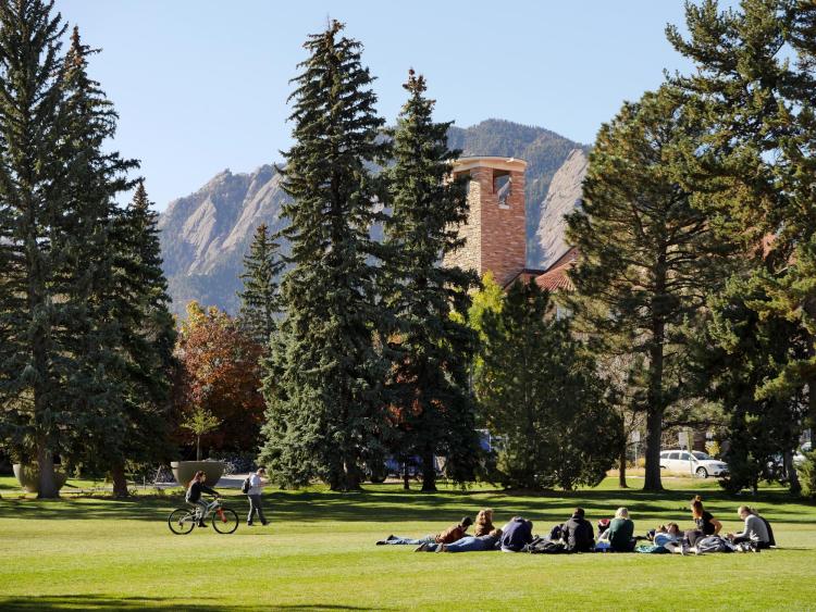 A class takes place outdoors on a grassy lawn.