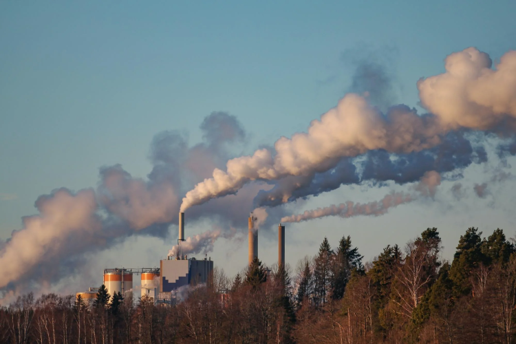 Factory smokestacks billowing smoke