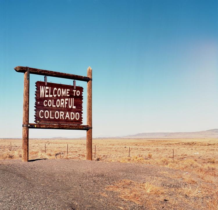 The 'welcome to colorful colorado' sign stands along a Colorado highway.
