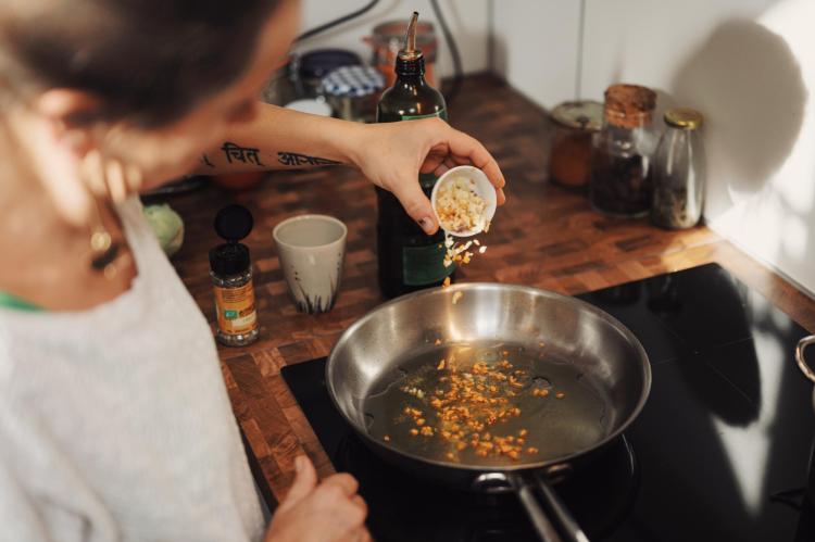 Someone cooking in pan