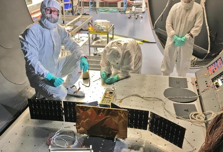 Researchers prep the CSIM CubeSat for testing
