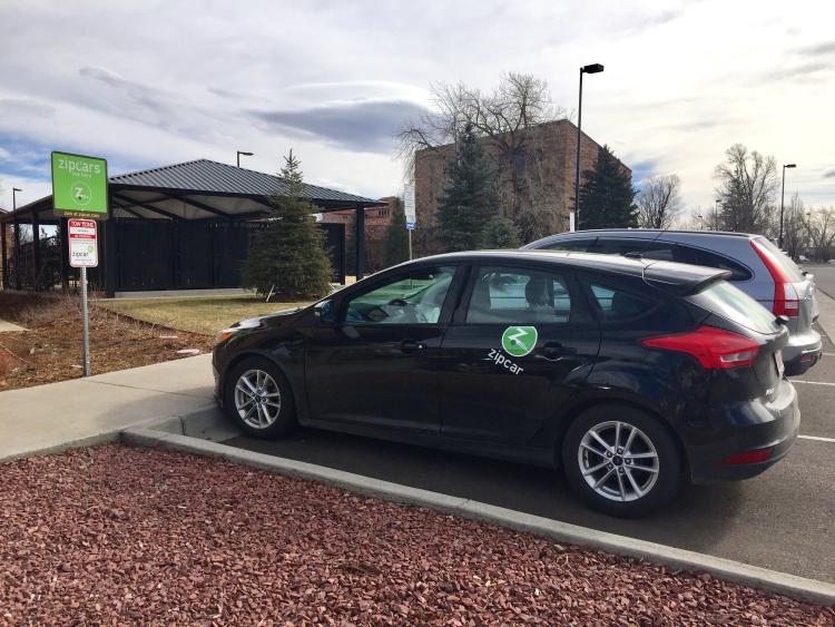 A Zipcar is parked on campus.