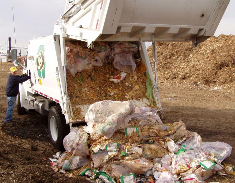 Truck with compost bags off-loads compost collected from campus