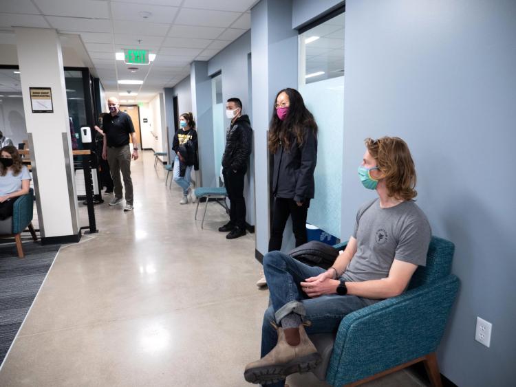CU Boulder students wait in a campus building before embarking on a national study