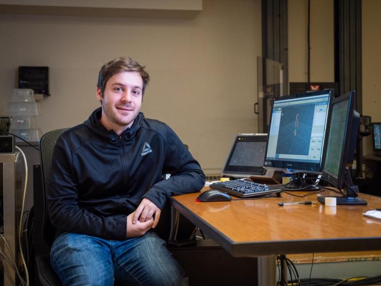 Doctoral student Joshua Tacca at computer