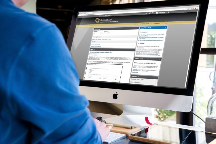 Man accesses D2L on desktop computer