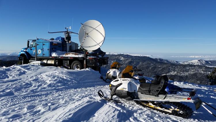 A Doppler radar system sits on the flatbed of a truck.