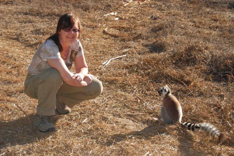 Michelle Sauther poses next to a ring-tailed lemur