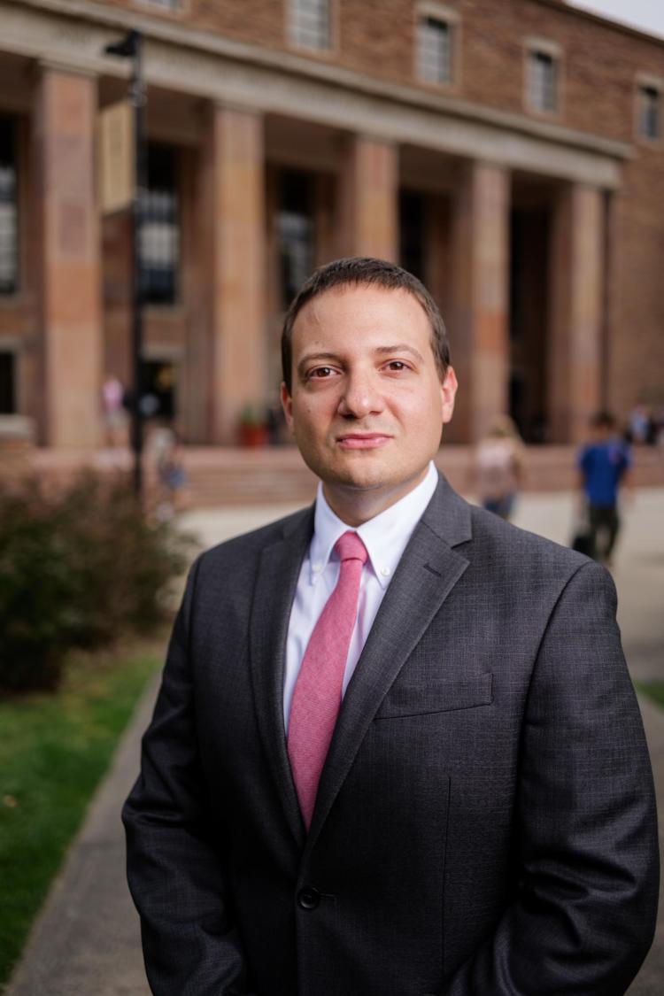 Man in suit posing for photo