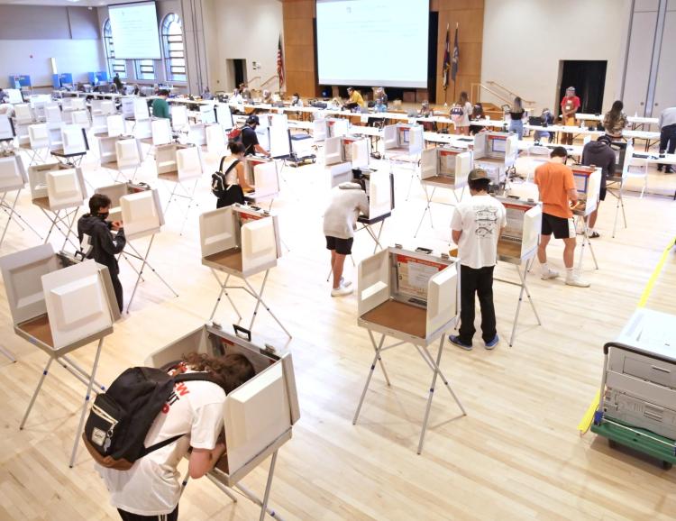student casting ballot in the UMC Vote Center