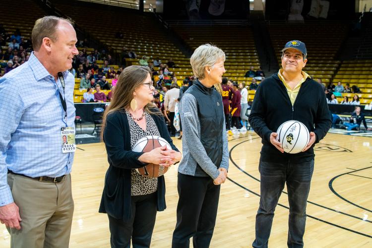 The four 2019 Chancellor’s Employee of the Year winners were honored during halftime of a recent Colorado basketball game. Left to right in this photo are: Athletic Director Rick George, Melynda Slaughter, Ceal Barry and Alex Viggio. (Photo by Patrick Wine/University of Colorado)
