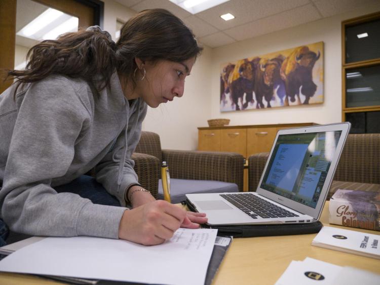 Student registers for classes on laptop