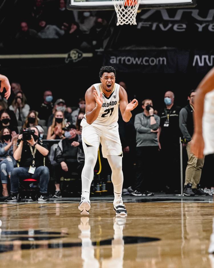 Evan Battey cheers from the court.