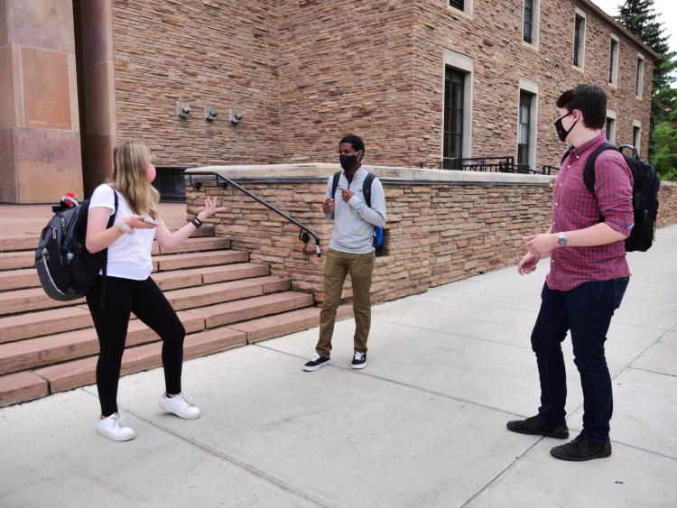 students talk on campus
