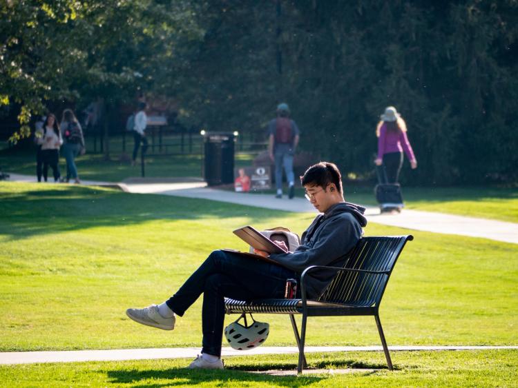 Students enjoy a warm fall day in the Norlin Quad. (Photo by Glenn Asakawa/University of Colorado)