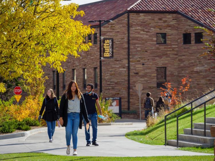 students walking outdoors on campus