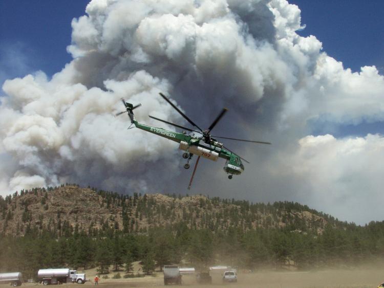 A helicopter flies over the Hayman fire