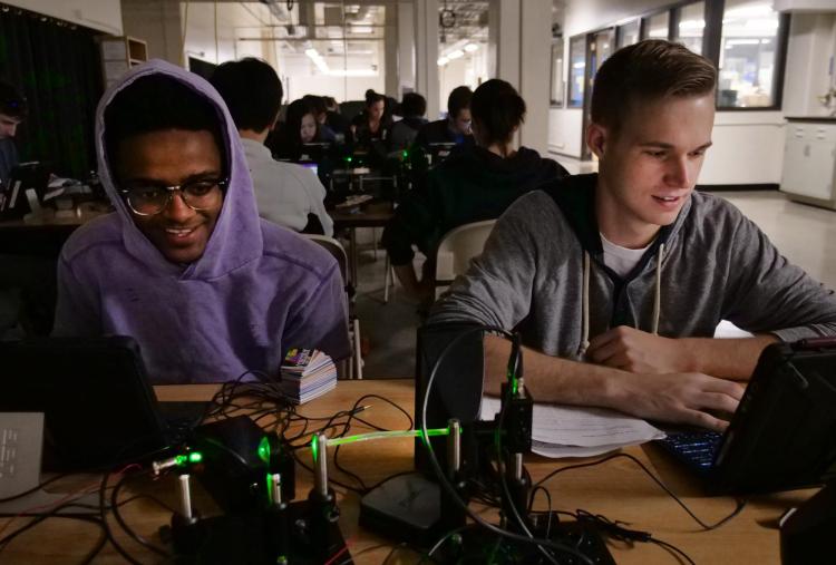 Electrical engineering major Nathan Tadele, left, and mechanical engineering major Ryan Cochran work on an assignment in a physics fiber optics class. Photo by Casey A. Cass.
