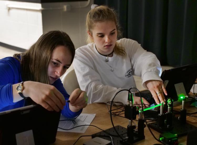 Applied math major Lindsay Gettel, left, and electrical engineering major Nicole Makey work on an assignment in a physics fiber optics class. Photo by Casey A. Cass.