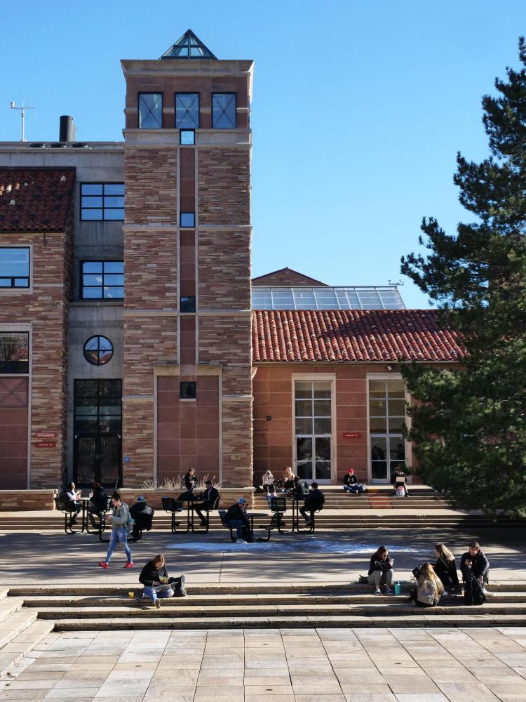 Students sit on steps outside the UMC
