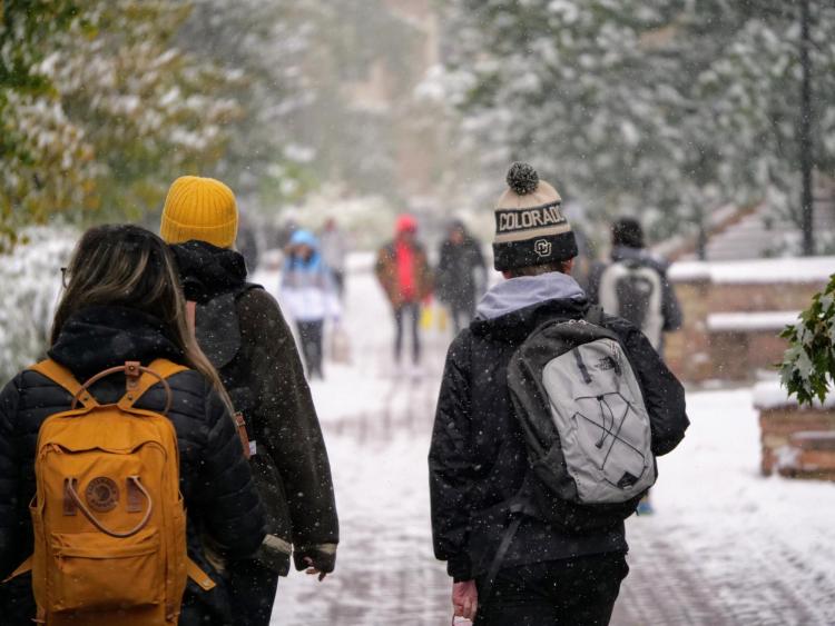 Campus community members walking on a snowy campus