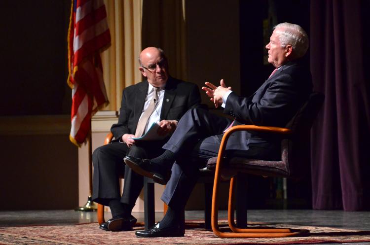 Robert Gates chats with CU Boulder Chancellor Philip DiStefano at CU Boulder at Macky Auditorium.