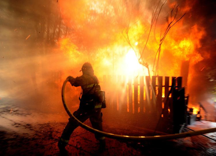 a firefighter extinguishing a blaze in California