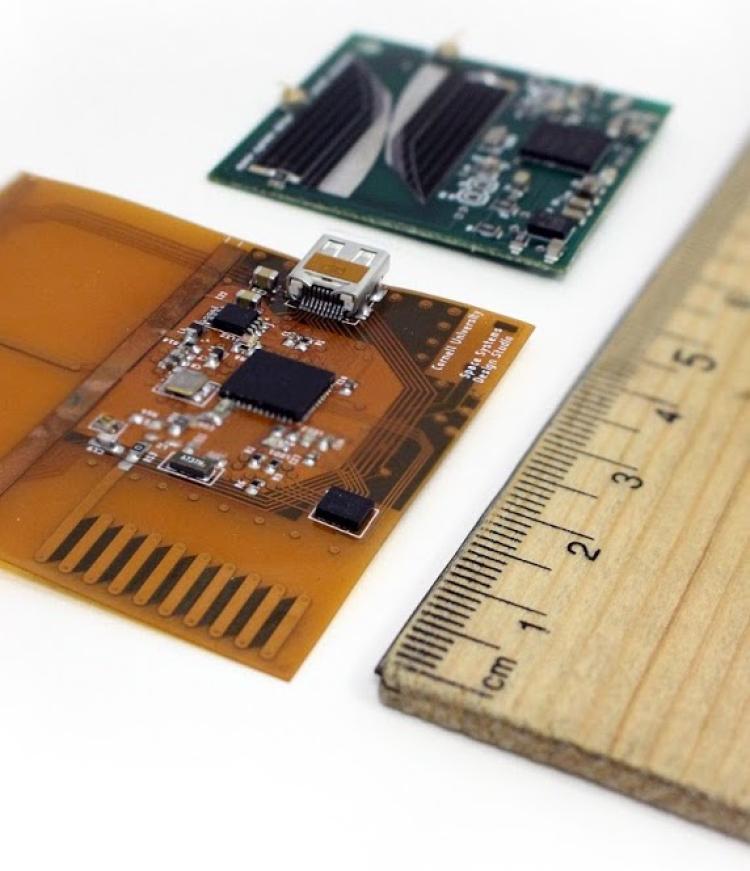 A prototype LunaSat sitting next to a ruler